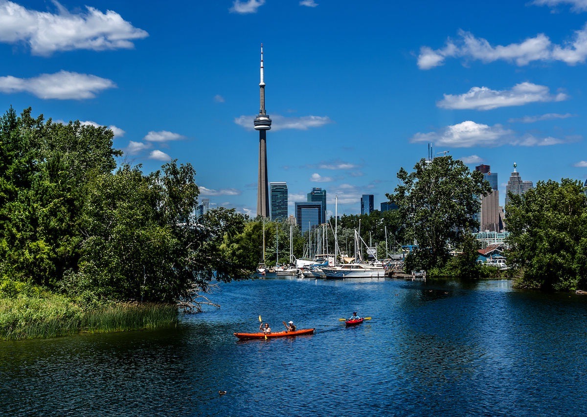 Kayakers on the Toronto Islands with the skyline and CN Tower behind